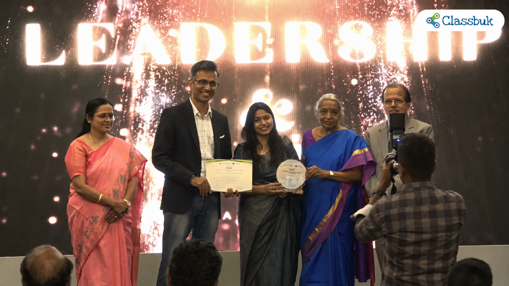 Classbuk founders  receiving an award and recognition certificate 